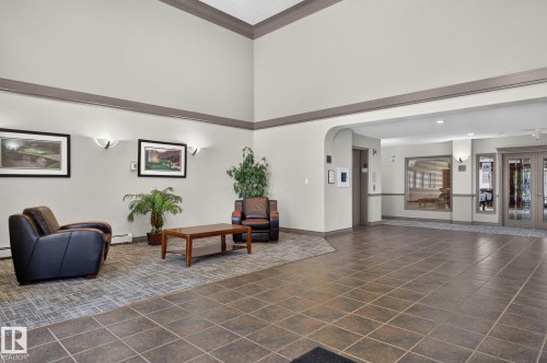 Spacious foyer featuring a neutral color palette with high ceilings and crown molding - 122 279 Suder Greens Drive, Edmonton, AB 
