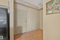 Entryway with wood-finish flooring, a paneled door, and neutral wall paint - 