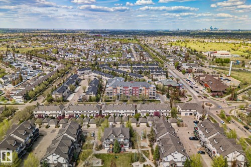 Aerial perspective showcasing a residential community with townhouses and multi-story apartment buildings - 209 5280 Terwillegar Boulevard, Edmonton, AB - Outdoor With View