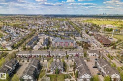 Aerial perspective showcasing a residential community with townhouses and multi-story apartment buildings - 
