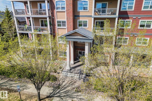 Multi-story residential building featuring a brick and siding facade with numerous windows and private balconies - 209 5280 Terwillegar Boulevard, Edmonton, AB - Outdoor With Balcony