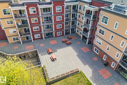 Central courtyard featuring paver stone surfacing with integrated red accent squares - 209 5280 Terwillegar Boulevard, Edmonton, AB - Outdoor
