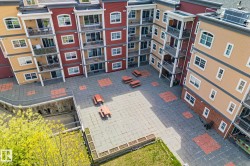 Central courtyard featuring paver stone surfacing with integrated red accent squares - 
