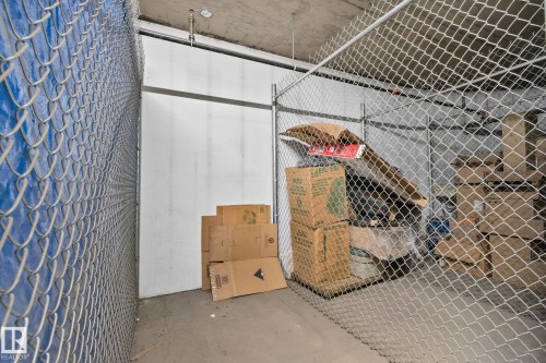 Dedicated storage unit featuring chain-link fencing, concrete flooring, and a concrete ceiling - 209 5280 Terwillegar Boulevard, Edmonton, AB - Indoor