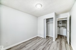 Light-filled room featuring wood-finish flooring, a flush-mount ceiling light, and white baseboards - 