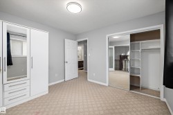 Bedroom featuring patterned carpet, light grey walls, and a flush mount ceiling light - 