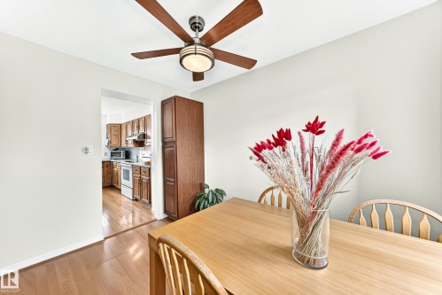 Dining area featuring wood-finish flooring and a ceiling fan with integrated lighting - 102 Royal Terrace, Edmonton, AB 