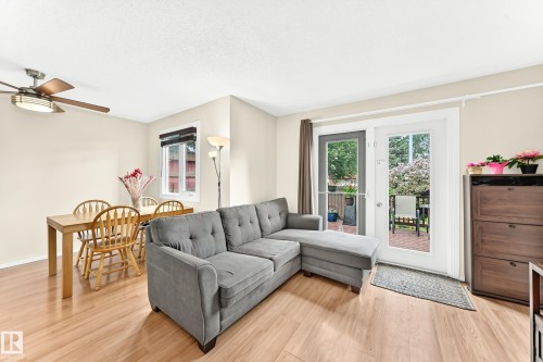 Open concept living area featuring light-toned walls and wood-finish flooring - 102 Royal Terrace, Edmonton, AB 