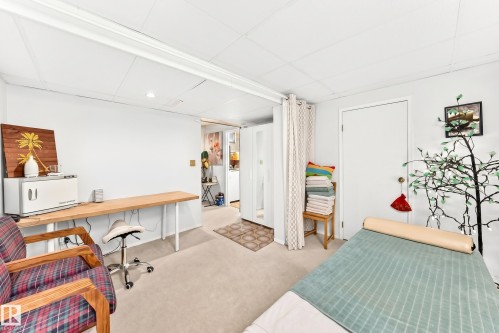 Carpeted room featuring recessed lighting, a long wood-finish table, and white walls - 102 Royal Terrace, Edmonton, AB 