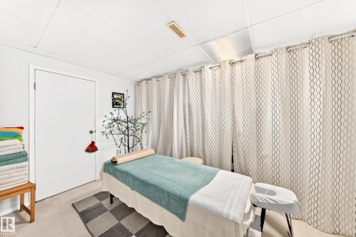 Carpeted room with a drop ceiling featuring recessed lighting - 102 Royal Terrace, Edmonton, AB 