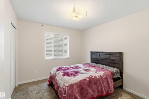 Neutral-toned walls complement a window with white louvered shutters - 5120 19 Avenue, Edmonton, AB 