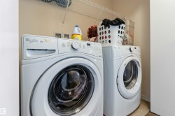 Dedicated laundry area featuring a front-load washer and dryer set - 