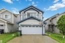 Two-story residence featuring light-colored siding and contrasting blue trim - 5120 19 Avenue, Edmonton, AB 