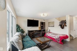 Living area featuring wood-finish flooring and light-toned walls - 