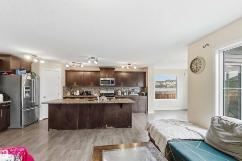 Open-concept kitchen and living area featuring wood-finish flooring - 5120 19 Avenue, Edmonton, AB 