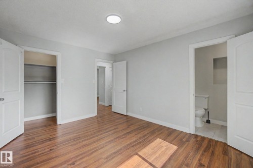 Spacious room featuring wood-finish flooring and light gray wall paint - 1511 75 Street, Edmonton, AB 