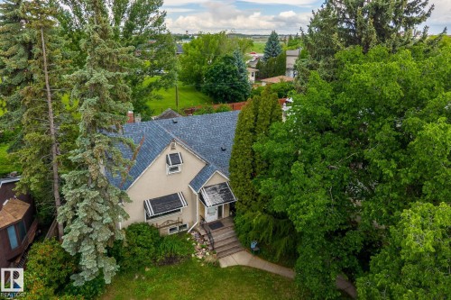 Cream-colored stucco exterior with a multi-gabled roof and dark shingles - 11022 110 Avenue, Edmonton, AB 