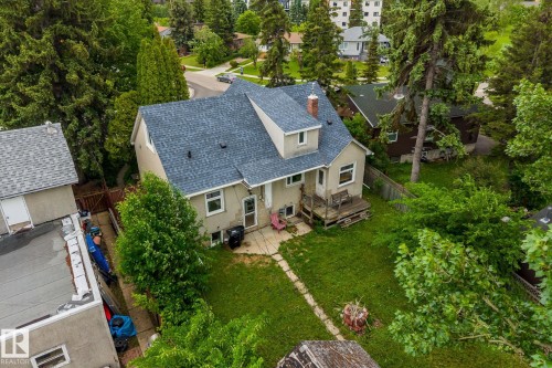 Residential property featuring a shingle roof and stucco exterior - 11022 110 Avenue, Edmonton, AB 
