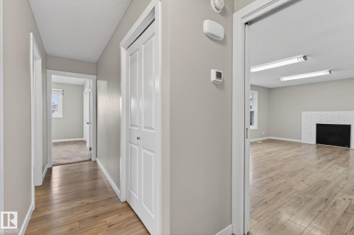 Wood-finish flooring throughout the hallway and open room - 15112 80 Street, Edmonton, AB 
