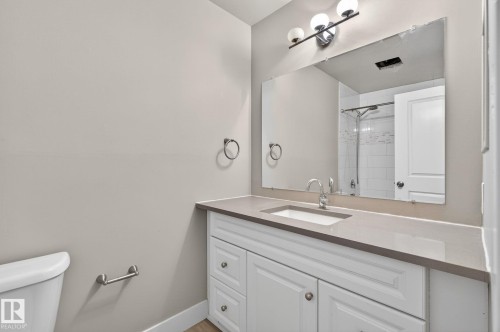 Vanity with an integrated sink and light-toned countertop - 15112 80 Street, Edmonton, AB 