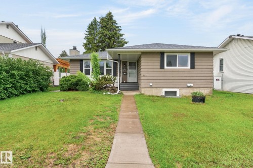 Tan siding exterior with a dark grey roof - 15112 80 Street, Edmonton, AB 