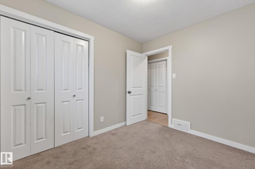 Neutral-toned walls complement the textured carpet flooring - 15112 80 Street, Edmonton, AB 
