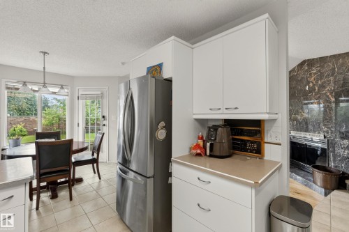 Kitchen area featuring white cabinetry, light countertops, and tile flooring - 9 Emerald Terrace, St. Albert, AB 