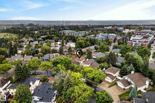 Aerial perspective showcasing a residential neighborhood with abundant mature trees and varied architectural styles - 9 Emerald Terrace, St. Albert, AB 