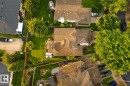 Expansive property featuring a multi-level roofline, mature trees, a manicured lawn, and a paved driveway - 9 Emerald Terrace, St. Albert, AB 