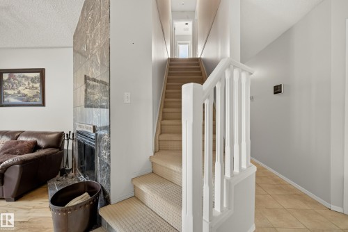 Carpeted staircase with white balusters leading to an upper level - 9 Emerald Terrace, St. Albert, AB 