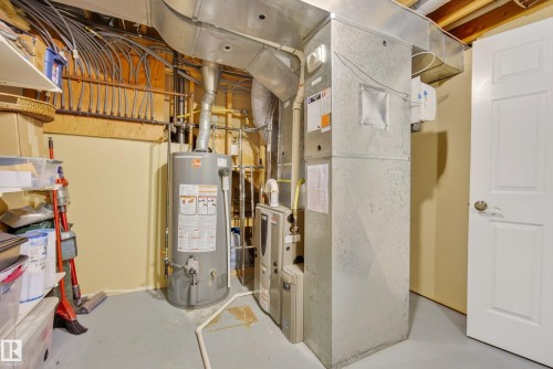 Utility room featuring water heater, furnace, and exposed ductwork - 9 Emerald Terrace, St. Albert, AB 