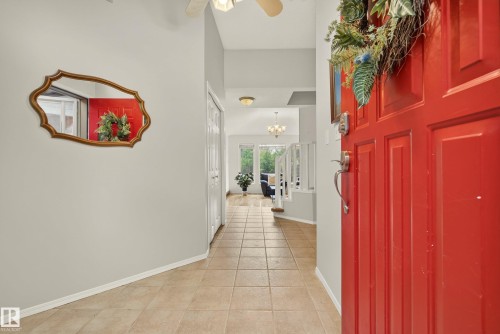 Entryway featuring a paneled red door, tile flooring, and light gray walls - 9 Emerald Terrace, St. Albert, AB 