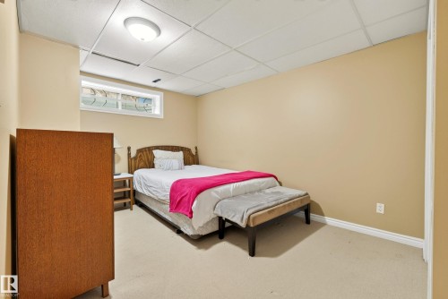 Carpeted room featuring a drop ceiling with recessed lighting, a horizontal window, and neutral-toned painted walls - 9 Emerald Terrace, St. Albert, AB 