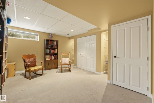 Finished lower level featuring recessed lighting, a drop ceiling, and neutral carpeting - 9 Emerald Terrace, St. Albert, AB 