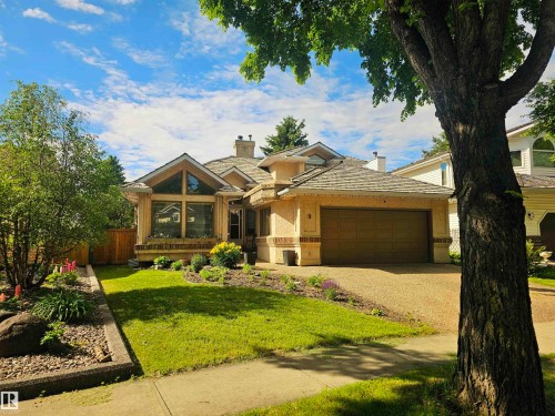 Residence featuring a two-car garage, stucco exterior, and multi-pane windows - 9 Emerald Terrace, St. Albert, AB 