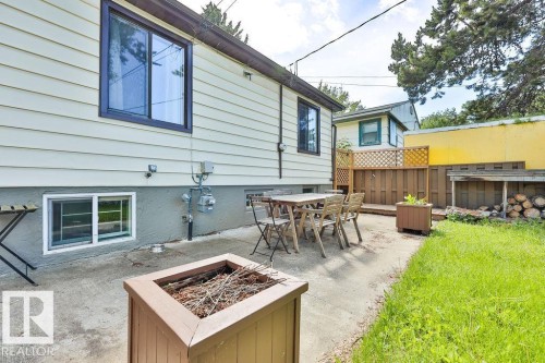 Concrete patio area with wood-finish fencing - 8318 80 Avenue, Edmonton, AB 