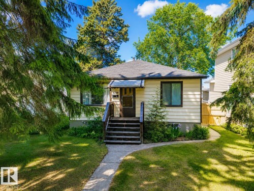 Single-story residence featuring light-colored siding and a dark roof - 8318 80 Avenue, Edmonton, AB 