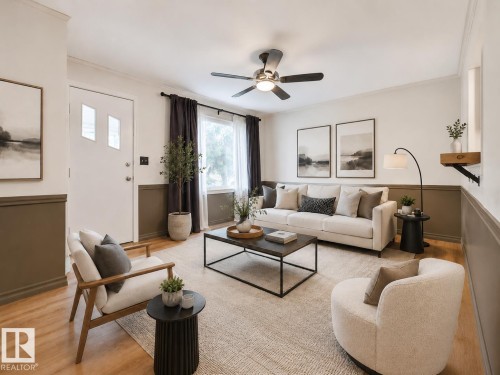 Bright living area featuring wood-finish flooring, a contemporary ceiling fan, and a neutral color palette - 8318 80 Avenue, Edmonton, AB 