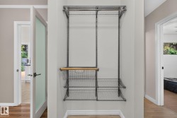 Custom wire shelving system featuring multiple shelves, two hanging rods, and an integrated basket drawer with a wood-finish handle - 