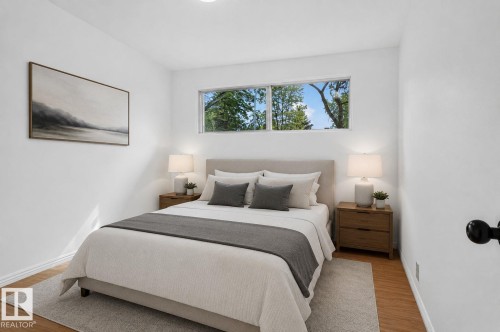 White walls featuring a horizontal window, wood-finish flooring, recessed lighting, and white baseboards - 12952 114 Street Nw, Edmonton, AB 