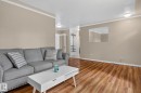 Open-concept living space with wood-finish flooring - 12952 114 Street Nw, Edmonton, AB 