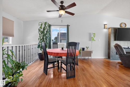 Spacious open-concept interior featuring wood-finish flooring, vaulted ceilings, and a ceiling fan with integrated lighting - 10935 152 Street, Edmonton, AB 