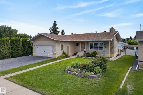 Ranch-style residence featuring a single-car garage with a paved driveway - 10935 152 Street, Edmonton, AB 