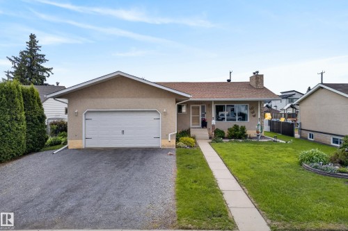 Ranch-style residence featuring a prominent attached garage with a white overhead door - 10935 152 Street, Edmonton, AB 