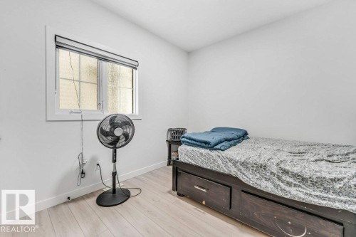 Bright room with wood-finish flooring and a white window frame - 423 28 Street, Edmonton, AB 