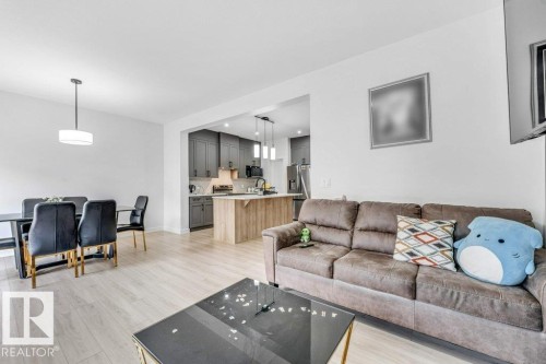 Open-concept living space featuring light wood-finish flooring throughout - 423 28 Street, Edmonton, AB 