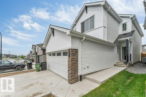 Contemporary home with white siding, an attached garage, and stone accents - 423 28 Street, Edmonton, AB 