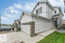 Contemporary home with white siding, an attached garage, and stone accents - 423 28 Street, Edmonton, AB 