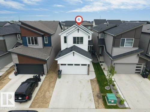 Contemporary two-story residence featuring a white vertical siding facade - 423 28 Street, Edmonton, AB 