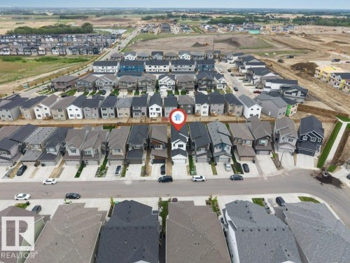 Aerial perspective showcasing a developed residential street with uniform detached homes - 423 28 Street, Edmonton, AB 